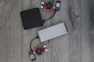 Two portable USB-C laptop power banks plugged into load testers.