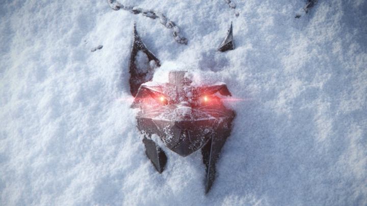 A wolf head with glowing red eyes in the snow.