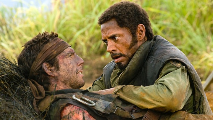 Robert Downey Jr. holding down Ben Stiller in a scene from Tropic Thunder.